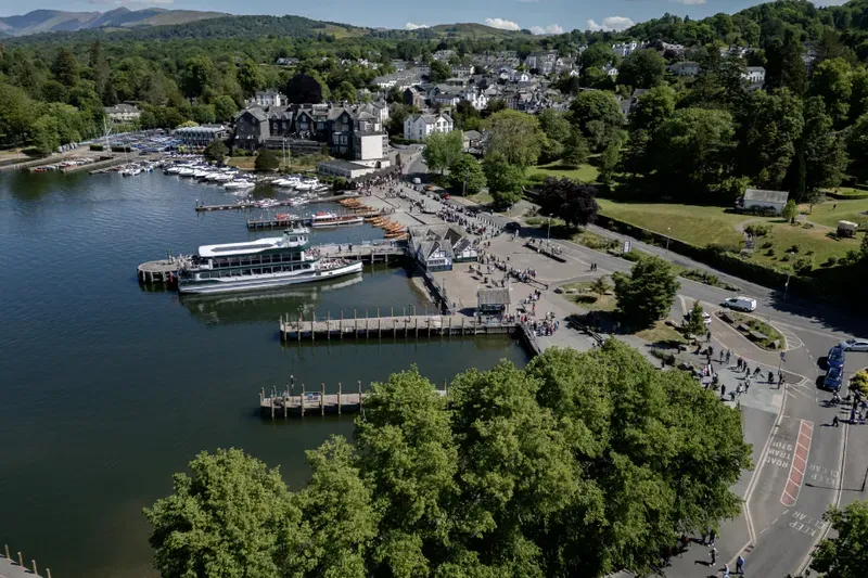 Lake Windermere, with boats at the piers and the fells behind